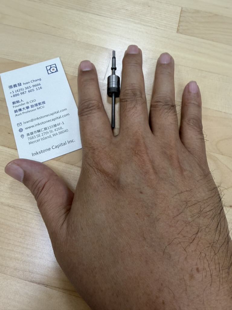 Small precision component shown on a hand for scale